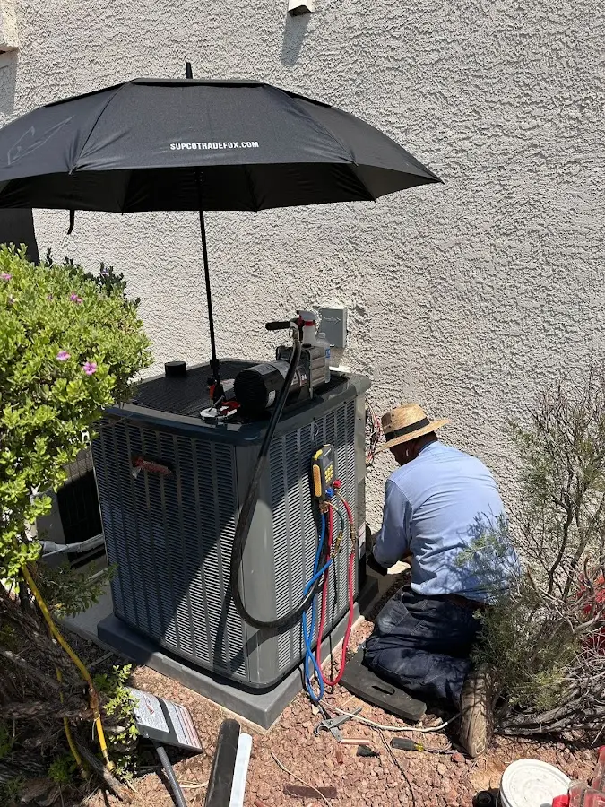 HVAC technician performing outdoor AC maintenance in Epping
