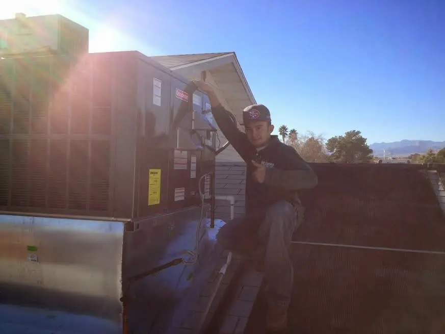 HVAC technician performing Boiler Repair on a rooftop unit in Epping